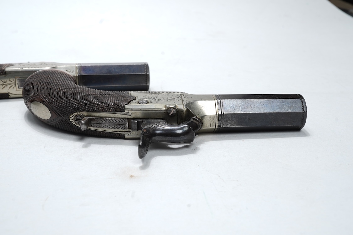 A pair of boxlock percussion pocket pistols with 4cm octagonal barrels, the frames engraved Lacy & Co., London, with London proof marks and rounded chequered walnut butts (2)